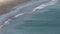 Aerial view of waves breaking to shore