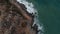 Aerial view. Waves crashing against rocks. Sea waves on dangerous rocks from a bird`s-eye view. 4K. Bird`s-eye view of