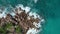 Aerial view of waves crashing into rocky peninsula in Praslin, Seychelles