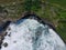 Aerial view of the waves hitting the coastal reefs