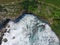 Aerial view of the waves hitting the coastal reefs