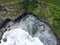 Aerial view of the waves hitting the coastal reefs