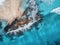 Aerial view of waves, rocks and transparent sea