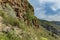 Aerial view of west coastline at sunny day. Blue sky and clouds. Rocky tracking road in dry mountain area. Tenerife, Canary Island