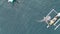 Aerial view of whale sharks playing with tourists on the boat