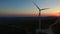 Aerial view of a white big windmill at colorful sunset