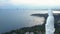 Aerial view white buddha statue on ocean coast hilltop