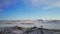 Aerial view. White buddhist stupa on top of snowy hill. Frozen ice lake around