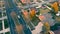 Aerial view of a white car driving through the streets of an empty town. The drone is watching the car going home.