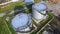 Aerial view white fuel storage tank in oil refinery plant. Stock. Top view white Industrial tanks for petrol and oil