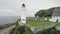 Aerial view of white lighthouse in hillside valley