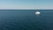 Aerial view of a white passenger ship sailing on the blue water sea