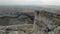 Aerial view of White Rock, Crimean Peninsula. There are cars at the top of the high cliff. Tourists stroll along the