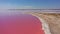 Aerial view of White salt on the shores of the island in Pink Island and blue sky . Lake Lemuria, Ukraine. Lake