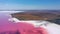 Aerial view of White salt on the shores of the island in Pink Island and blue sky . Lake Lemuria, Ukraine. Lake