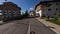 Aerial view white speed sports car riding asphalt road at suburb alpine resort street infrastructure