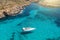 Aerial view of white yacht with moored sails in a tropical paradise lagoon turquoise water