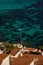 Aerial view of whitewashed houses with red tiles rooftops and sea