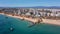 Aerial view of the wide and crowded Portuguese famous Rocha beach in Portimao, Algarve, Portugal. Drone shot