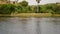 Aerial view of wild African hippopotamus in the river near the shore with bushes