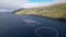 Aerial view of wild salmon in round meshes in the Faroe Islands