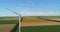 Aerial view of Wind electric turbines farm in agricultural fields in countryside. Windmills.