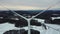 Aerial view of a wind farm in winter. Aerial view of a wind turbine in a snowy winter landscape. Flying through the wings of a