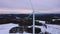 Aerial view of a wind farm in winter. Drone view of a wind turbine in a snowy winter landscape