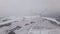 Aerial view of a wind farm in winter, rotating turbines on a snowy field in Ukraine