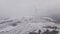 Aerial View of a Wind Farm in Winter, Rotating Turbines on a Snowy Field in Ukraine