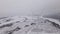 Aerial View of a Wind Farm in Winter, Rotating Turbines on a Snowy Field in Ukraine