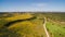 Aerial view of Wind Generating stations in green fields on a background of blue sky. Portugal.