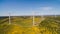 Aerial view of Wind Generating stations in green fields on a background of blue sky. Portugal.