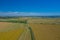 Aerial view of wind turbine. Windmills at harvest time, fields from above. Agricultural fields on a summer day. Renewable Energy