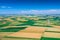 Aerial view of wind turbine. Windmills at harvest time, fields from above. Agricultural fields on a summer day. Renewable Energy