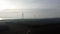 Aerial view of wind turbines in the sunset.