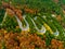 Aerial view of winding road through autumn colored forest