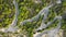 Aerial view of winding road in beautiful mountains at sunset