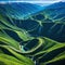 An aerial view of a winding road cutting through mountains or a coastal depicting