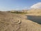 Aerial view of a winding road that runs along the Croatian coasts, dirt road, island of Pag near Rucica beach in Metajna. Croatia