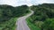Aerial view of winding road shaped like 3 on top of mountain in tropical rainforest at Nan province