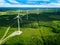 Aerial view of windmills in summer forest in Finland. Wind turbines for electric power with clean and Renewable Energy