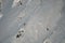 aerial view of winter mountain and brave male skier climbing up on it