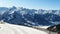 Aerial view of winter slope of Alps with sunny ski pathways