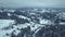 Aerial view winter village. Snowy tree branch in a view of the winter forest.