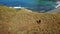 Aerial view of woman hikes hill on Padar Island