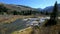 Aerial view of woman hiking on the rocky coast of lake in mountains-001