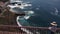 Aerial view of a woman overlooking the turquoise ocean with big waves, El Pris, Tenerife, Canary Islands, Spain