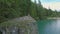 Aerial view of the woman sits on a cliff near Lago di Braies