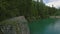 Aerial view of the woman sits on a cliff near Lago di Braies